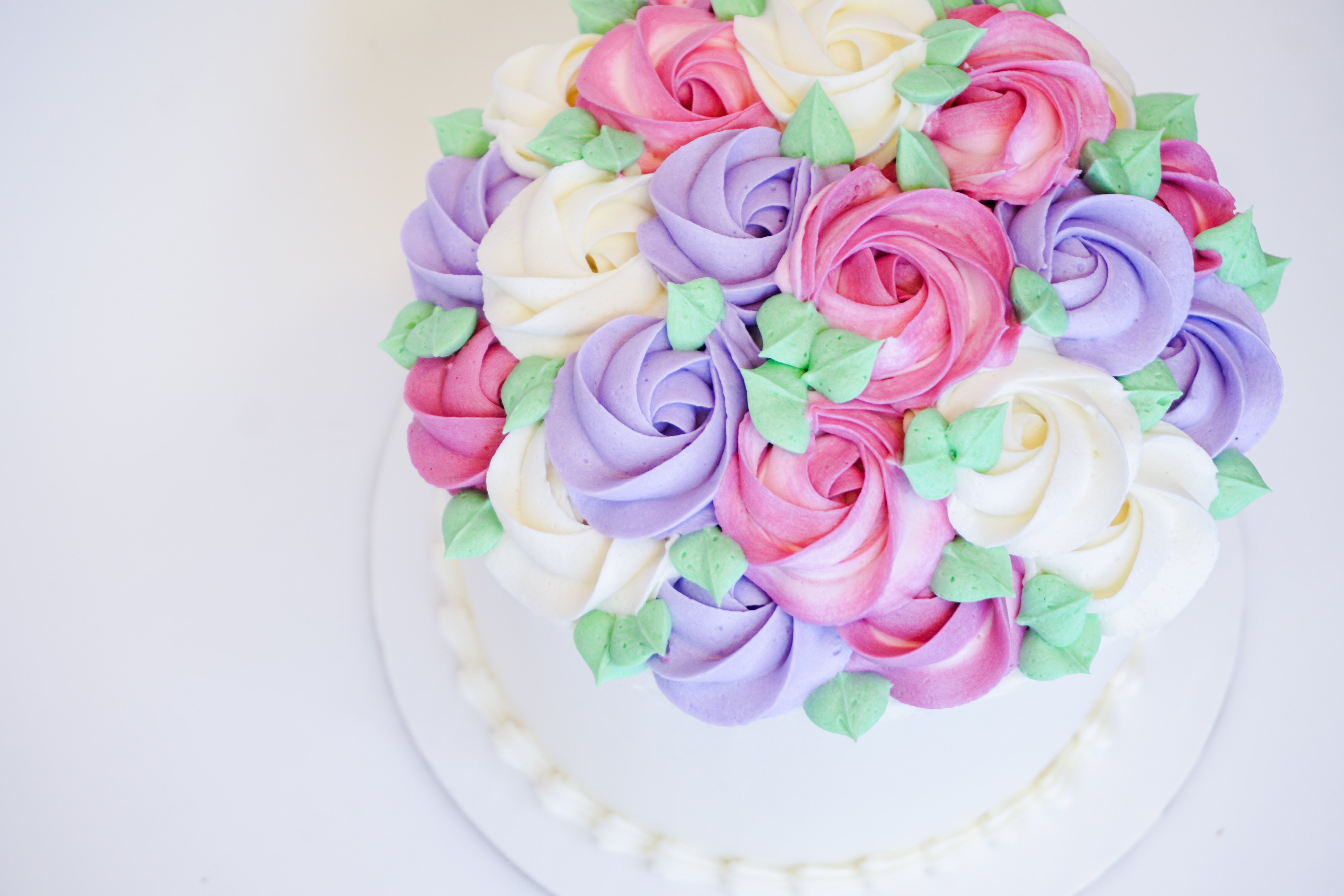 Elegant purple rosette cake decorated with fruit Stock Photo by ©TorriPhoto  101724208